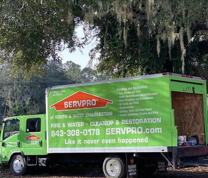 SERVPRO truck parked in a yard.