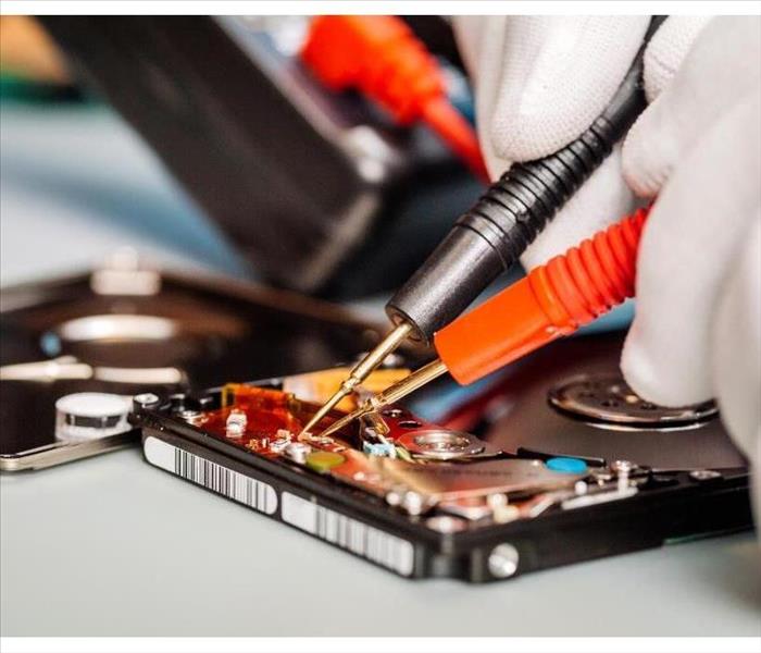 man repairing hard drive in service center. Repairing and fixing service in lab. Electronics repair service concept.